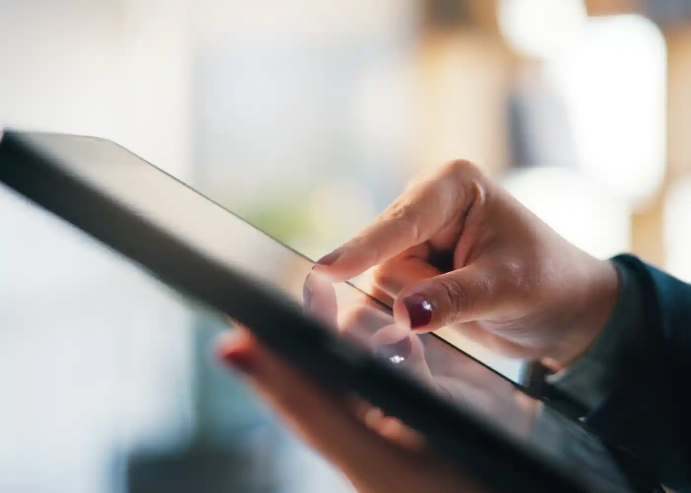 Woman reading news on tablet Woman reading news on tablet